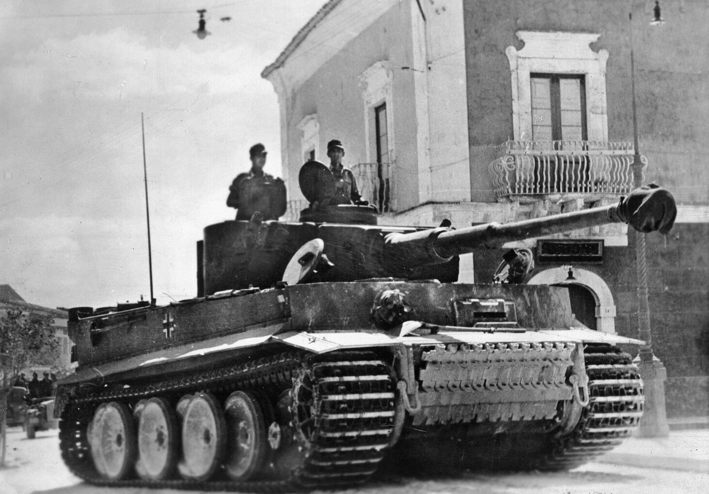 A German Tiger tank rolls through a rural village. Field Marshal Albert Kesselring shifted four elite divisions and a large number of Italian troops to the island to fight the Allied invaders.