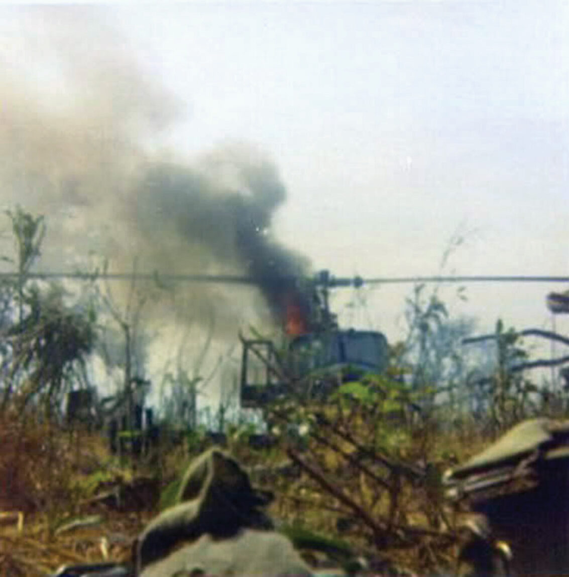 A downed U.S. helicopter erupts in flames at Landing Zone Lolo. The raid failed to cut the Ho Chi Minh Trail and emboldened the North Vietnamese to launch a major invasion of South Vietnam the following year.