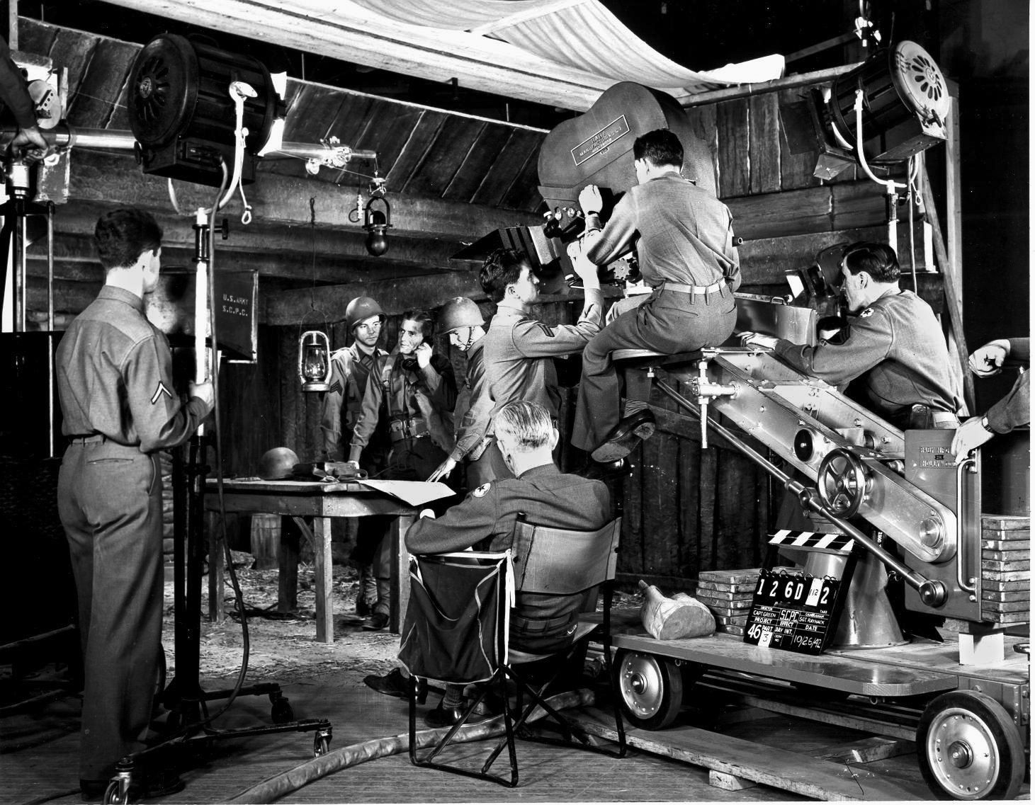 A U.S. Army Signal Corps film crew, including many who had once worked for Hollywood studios as civilians, shoots a scene for a training film. Hollywood fully supported the war effort and worked tirelessly to ensure victory.