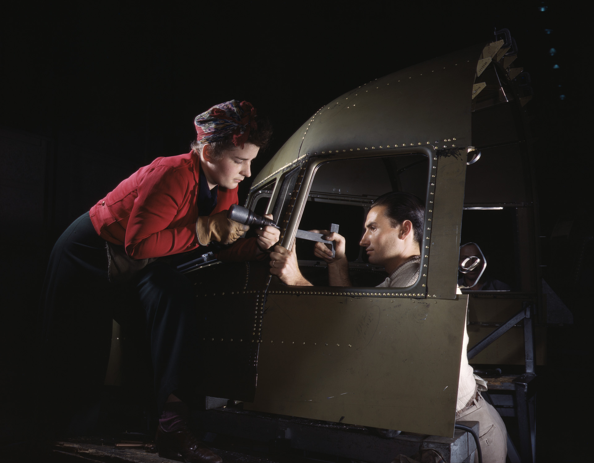 A riveting team working on the cockpit shell of a C- 47 transport plane at the North American Aviation plant in Inglewood, California.
