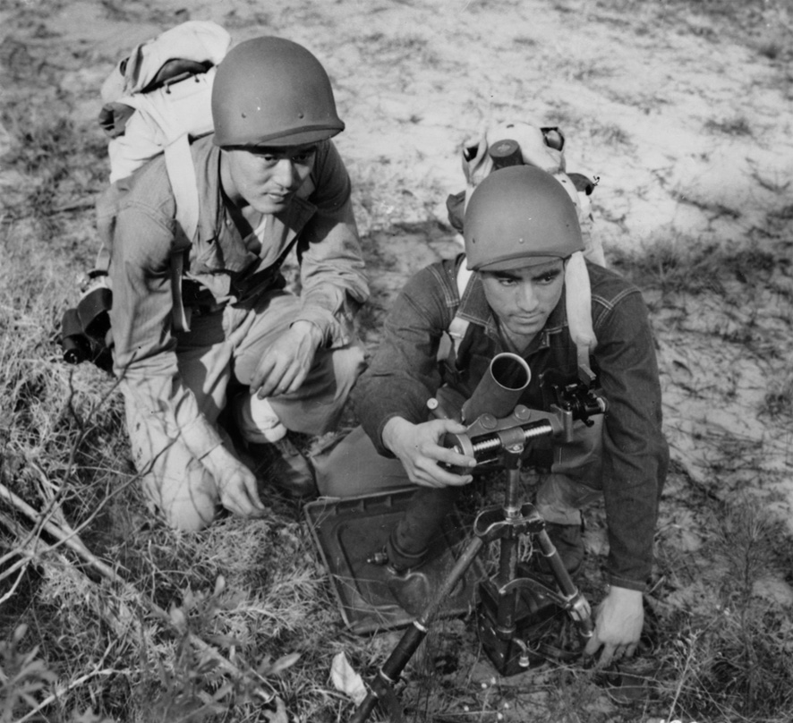 Two men of the 100th Infantry Battalion, formerly the Hawaii National Guard and now part of the 442nd RCT, set up a 60mm mortar during training at Camp Shelby, Hattiesburg, Mississippi, in 1943.