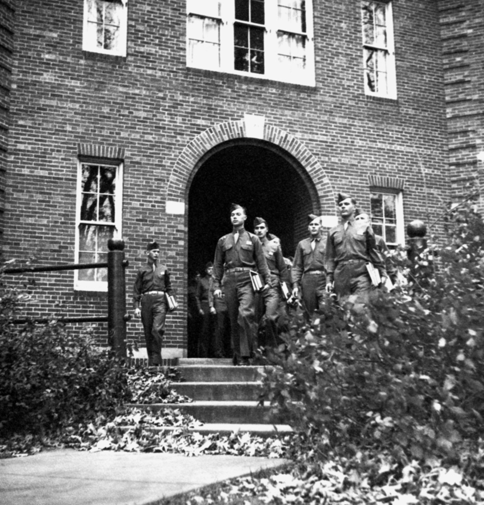 Maintaining a rigid military bearing, cadets march out of Morse-Ingersoll Hall, one of their classroom buildings, October 1943.