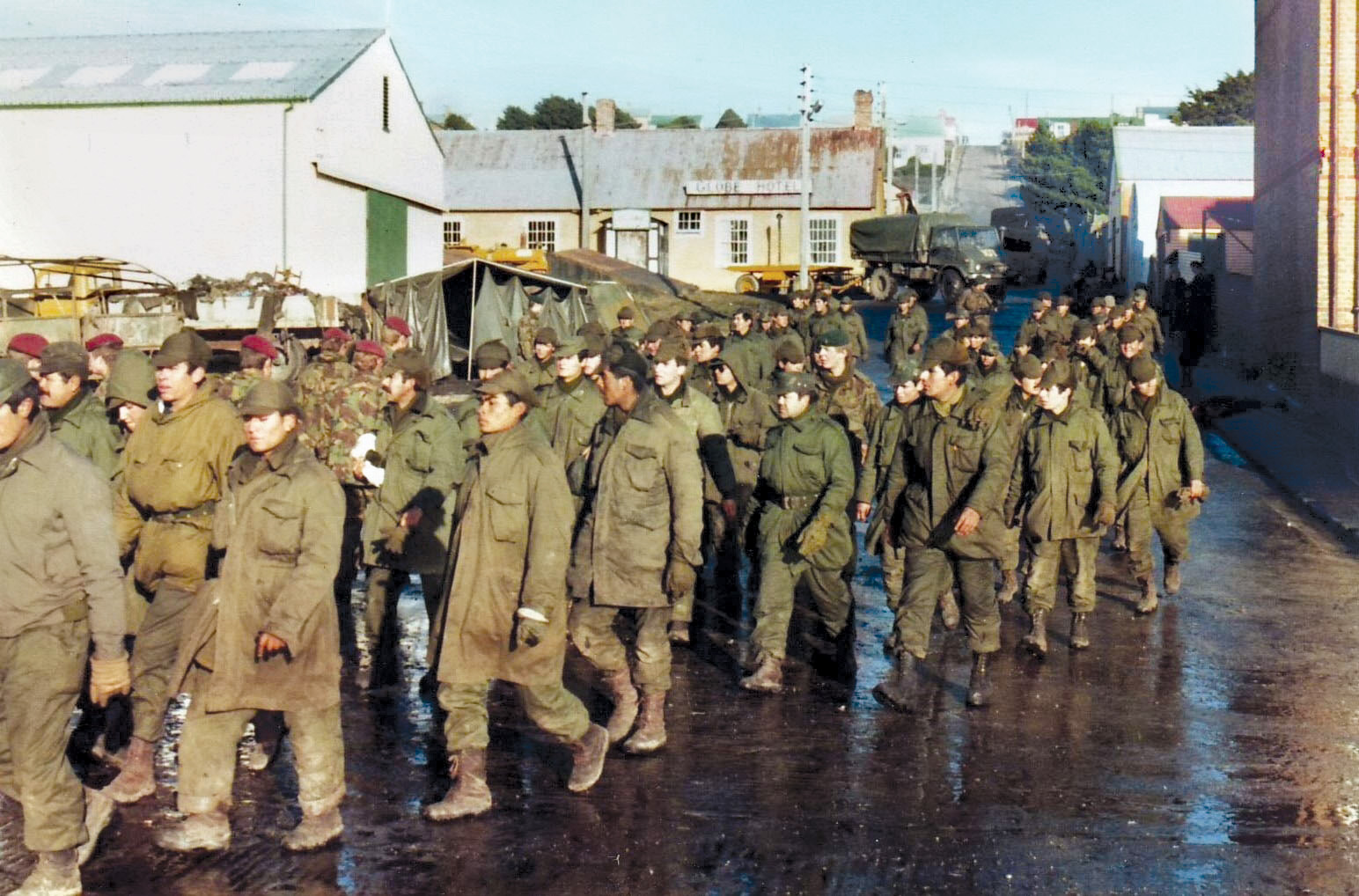 British soldiers lead Argentine prisoners through the streets of Port Stanley following the Argentine surrender on June 14, 1982. For the Argentines, who had miscalculated British resolve, the war was a shameful defeat.