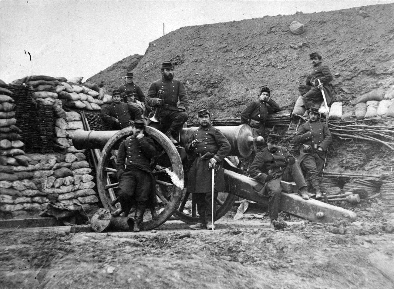 A French artillery crew is shown posing with a heavy gun during the Franco-Prussian War. The French muzzle-loading artillery was no match for the superior breech-loading Prussian guns, which the Prussians massed at key positions to overwhelm French defenses during the fighting at Gravelotte-Saint-Privat.