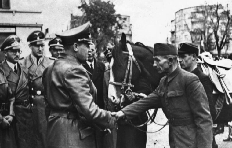Hans Frank, Governor-General of Nazi-occupied Poland, greets the commander of a Ukrainian militia unit as Gestapo officers look on. Frank pledged to annihilate the Jewish population of Poland—and nearly succeeded.