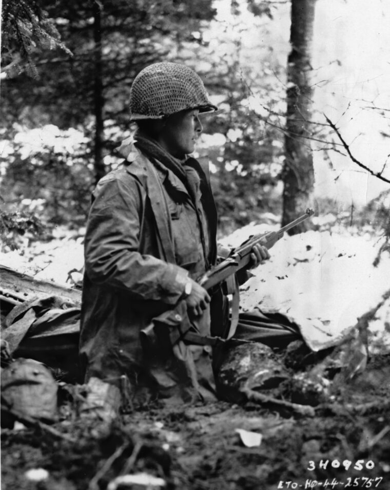 On alert for enemy activity in his snowy foxhole near St. Die, France, on November 13, 1944, is Sergeant Goichi Suehiro, a Japanese American (Nisei) machine-gun squad leader with Company F, 442nd Regimental Combat Team. He wears a rubberized raincoat and holds an M1 carbine. The 442nd saw extensive action in both Italy and France.