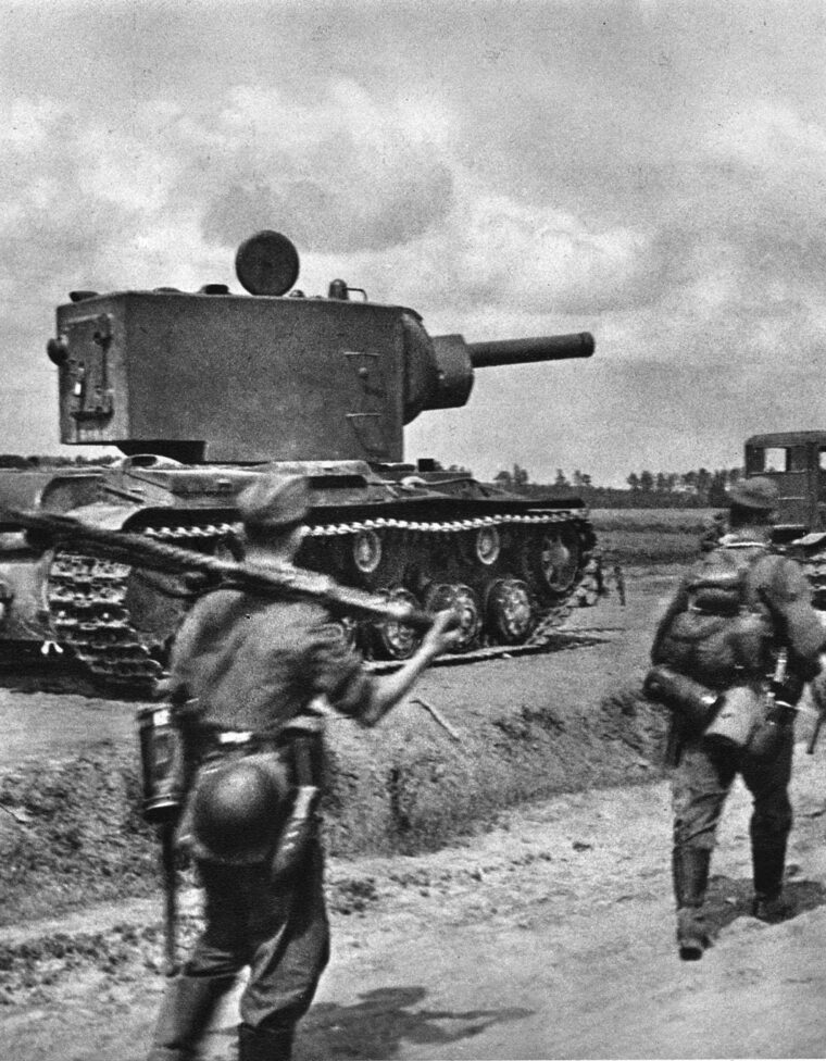 During the German invasion of the Soviet Union, German infantrymen pass an abandoned 62-ton Soviet Kliment Voroshilov KV-2 heavy tank with an M-10 152mm gun.