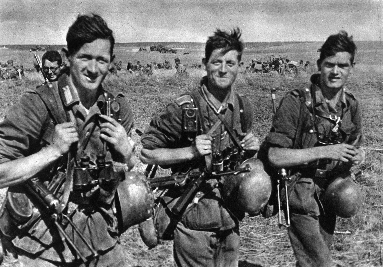 Although sun-burned and wind-blown, three Wehrmacht soldiers smile confidently, not realizing that disaster on the Eastern Front is in their future.