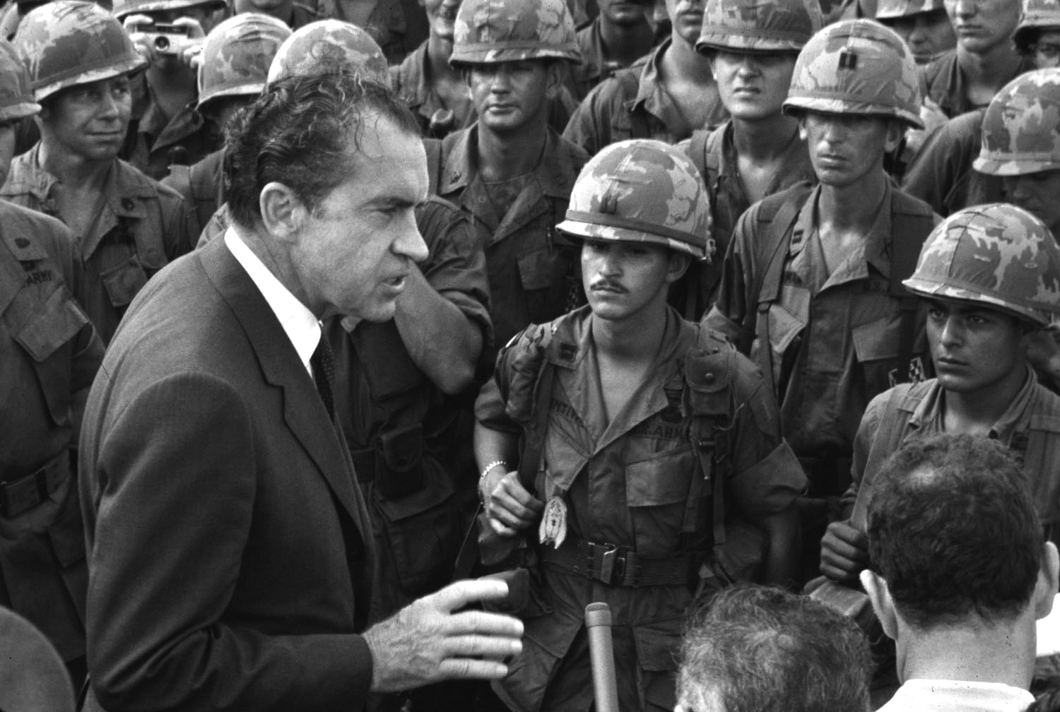 President Richard Nixon, shown with U.S. troops during the Vietnam War, became isolated politically in the White House during the Watergate crisis. He report- edly asked the Joint Chiefs of Staff whether military support was available to keep him in power.