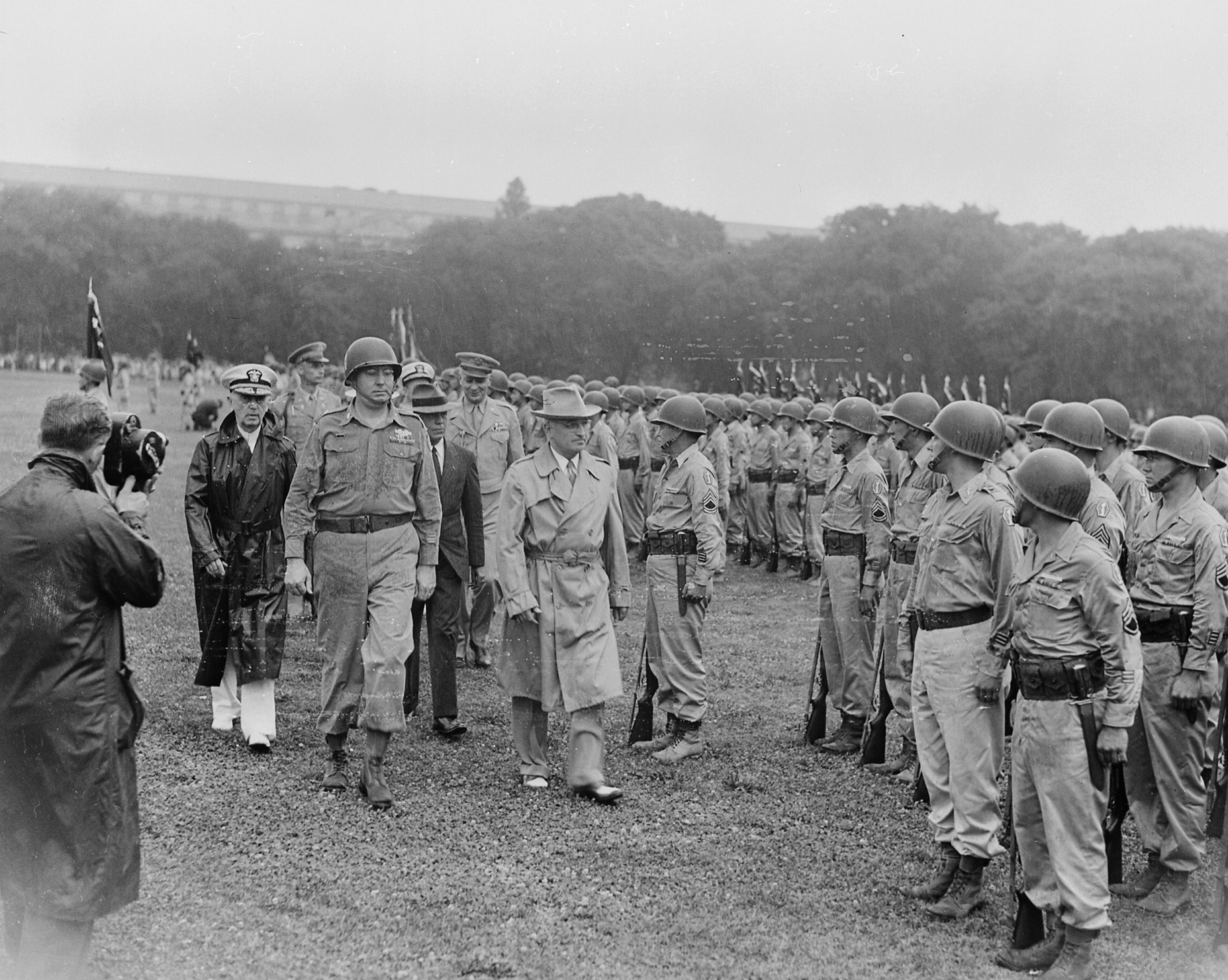 President Harry Truman (in trench coat) reviews troops from the 442nd RCT on the Ellipse in Washington, DC, July 15, 1946.