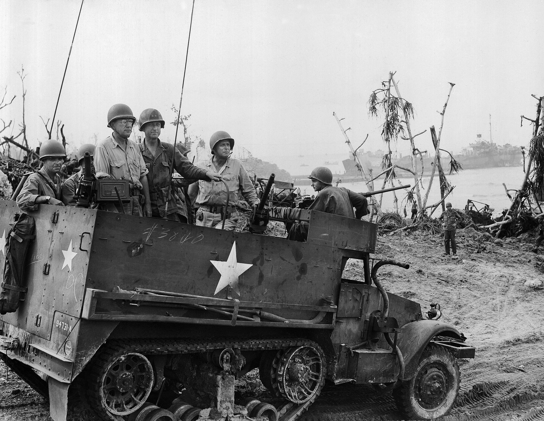 Observing the Army’s progress on Angaur from a half-track are Maj. Gen. Julian C. Smith (left, with glasses), commanding the Third Fleet’s amphibious troops; Maj. Gen. Paul J. Mueller (center), the 81st Division’s commander; and Marine Corps Lt. Gen. Roy Geiger, commander of III Amphibious Corps.