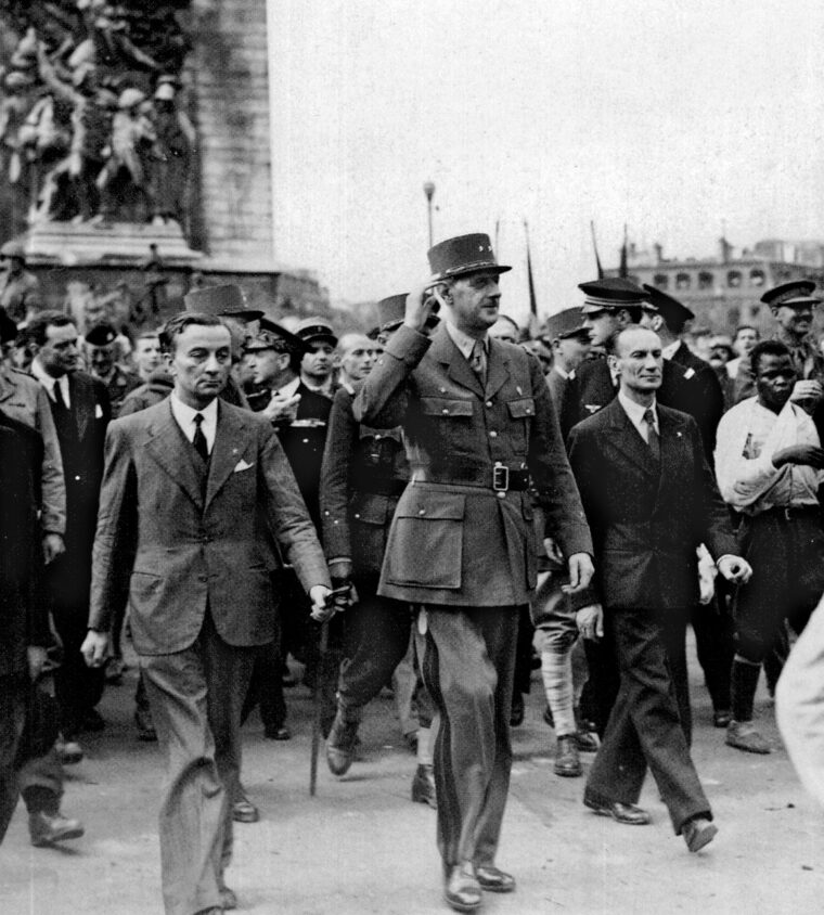 General Charles de Gaulle, head of the Free French movement, leads marchers down the Champs-Élysées in Paris on August 26, 1944, the day after the city’s liberation from the Germans by Allied forces. At left is Georges Bidault, head of the Conseil National de la Résistance.