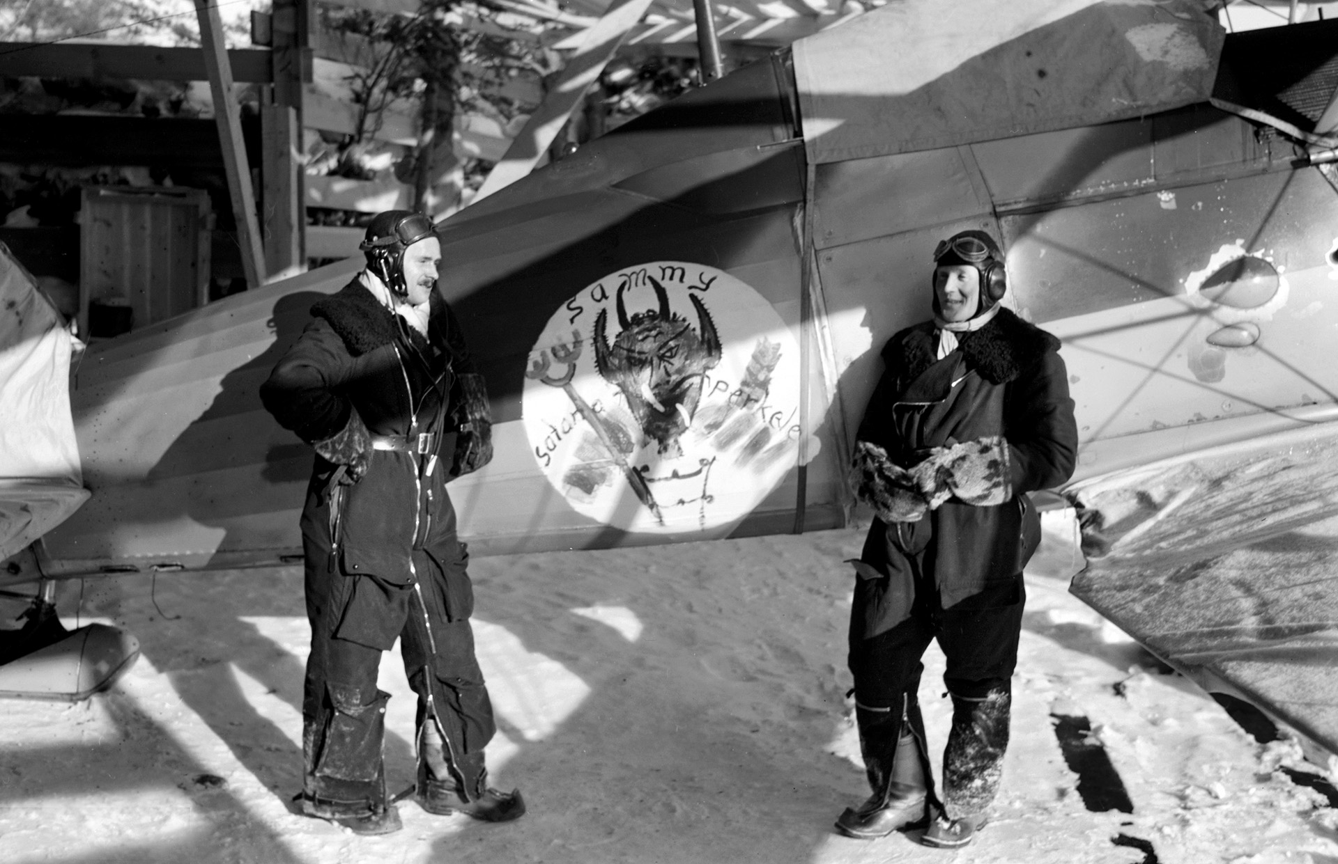 The Finns had help from volunteer Swedish airmen. Here, two Swedes, clad in heavy flight gear, stand beside a British-built Gloster Gladiator. The wide variety of aircraft from different nations caused supply and maintenance problems for the Finns.