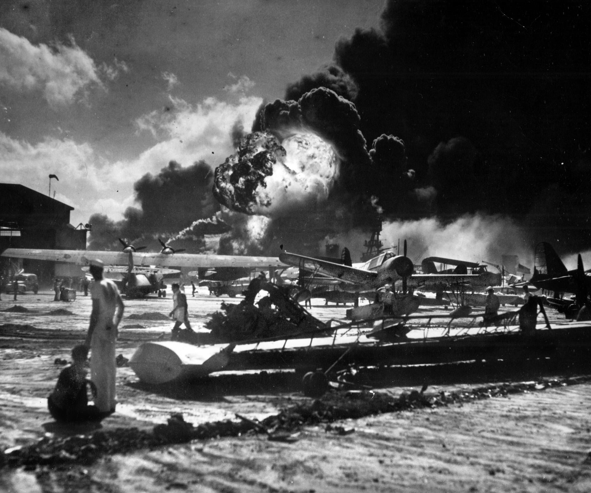 Planes explode at Ford Island, Pearl Harbor Naval Base, on December 7, 1941. The Japanese attack ignited a wave of fear and hatred toward anyone who looked Japanese. The result was the forced relocation of 110,000 American citizens into 10 high-security prison camps. 