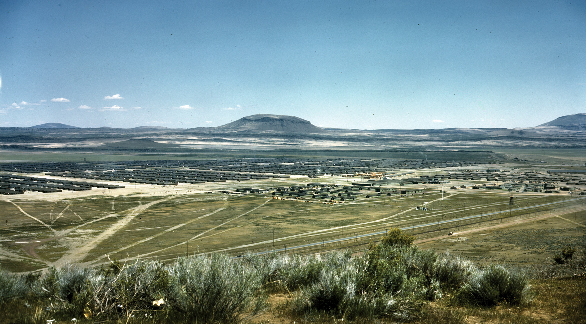 A wartime color aerial photo of the Tule Lake Relocation Center near Newell, California, and south of Klamath Falls, Oregon. Tule Lake was the largest of the 10 camps, with 18,700 inmates.