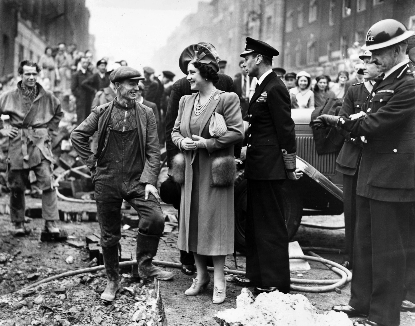King George IV and Queen Elizabeth talk with workers cleaning up bomb damage, October 18, 1940. After Buckingham Palace was bombed, the Queen said that having the royal residence damaged meant that she could empathize with the ordinary citizens.