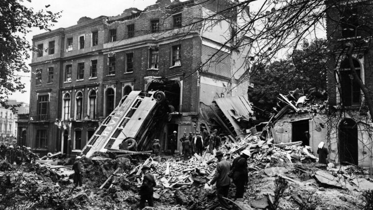A bus leans against the side of a terrace in Harrington Square after a German bombing raid on London. The bus was empty but 11 people were killed in the houses two days after the start of the attacks.