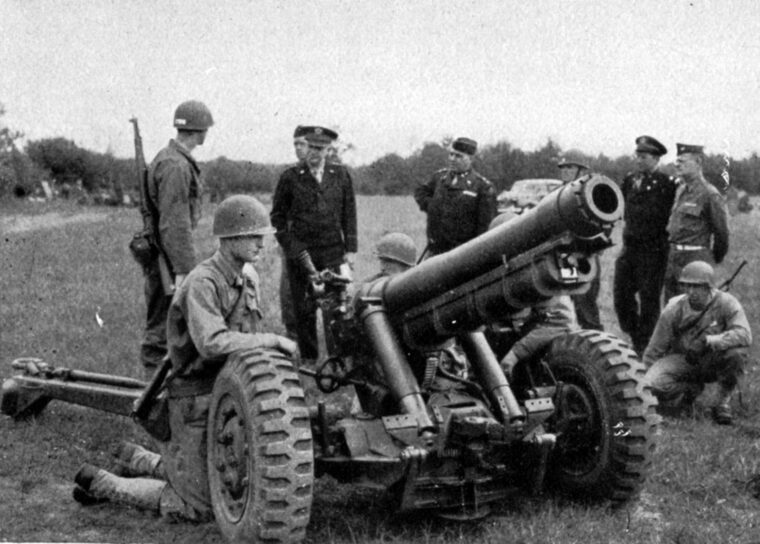 Supreme Allied Commander General Dwight D. Eisenhower inspects a gun crew of the 230th Field Artillery Battalion in England prior to D-Day. The unit arrived in France on June 10 and was heavily engaged in the battle for Hill 314 two months later. 