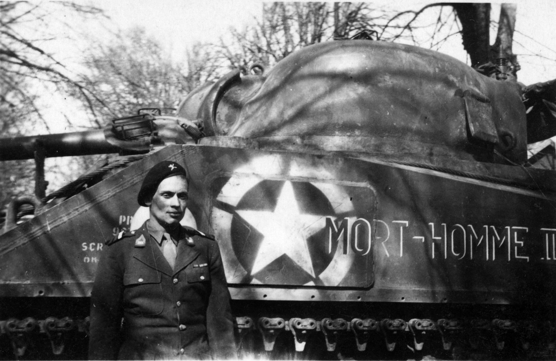 René, his cheek still recovering from burns received during a battle at Badonviller in November 1944, poses beside his tank shortly after the war.