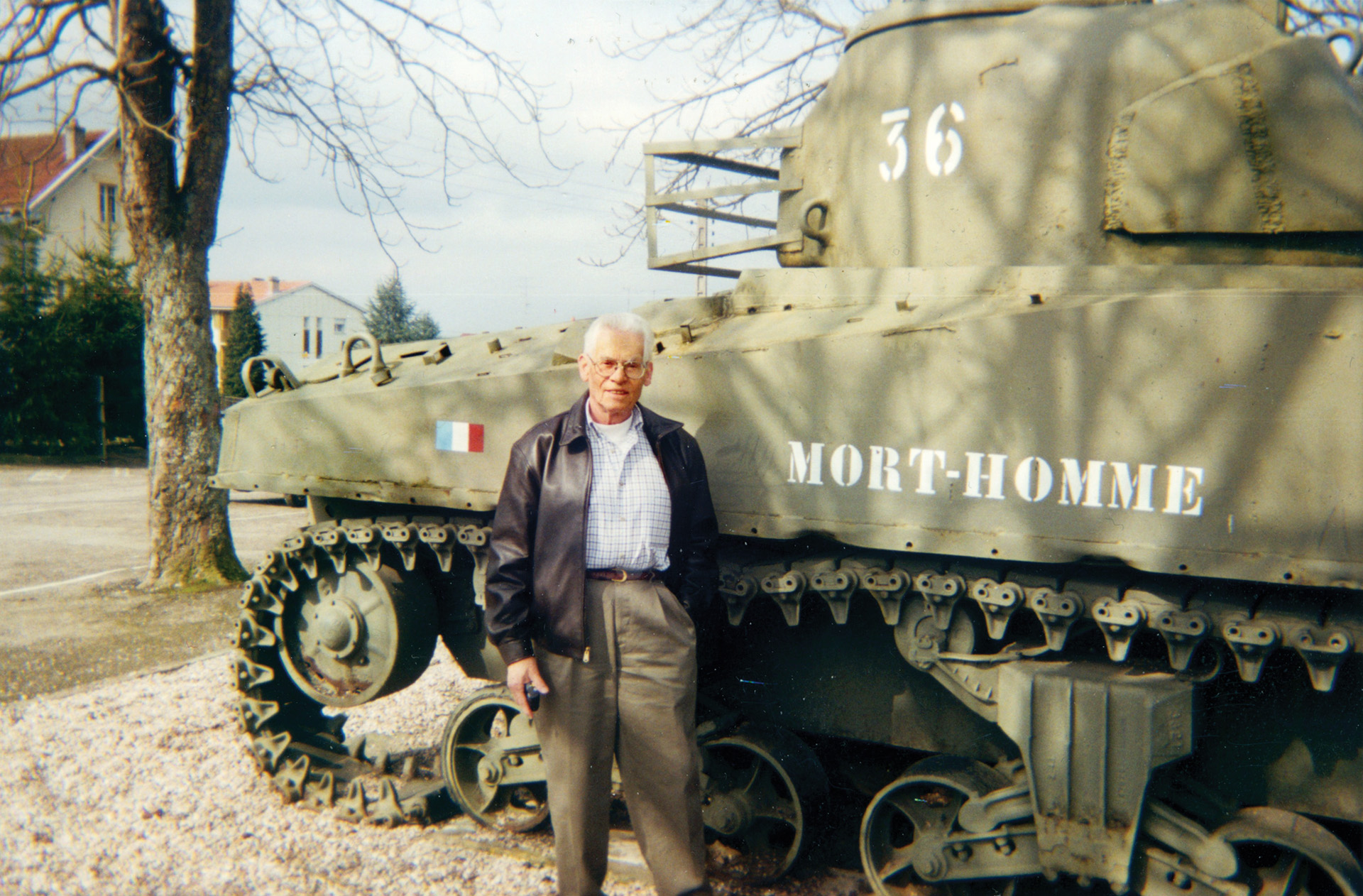 In 1994, on the 50th anniversary of the battle and liberation of the village of Badonviller, Rene poses with Mort-Homme III that today stands as a memorial in the town square. 