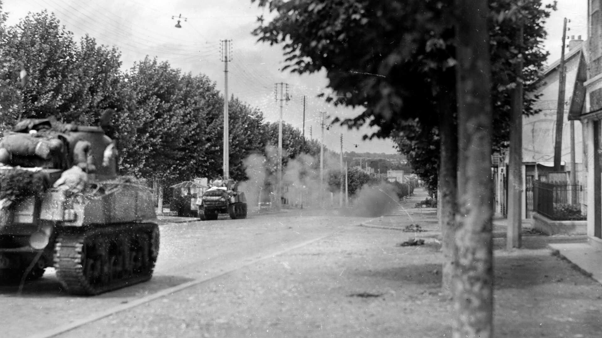 German shells fire on the tanks of the 2nd French Armored Division as they approach Paris on August 25, 1944.