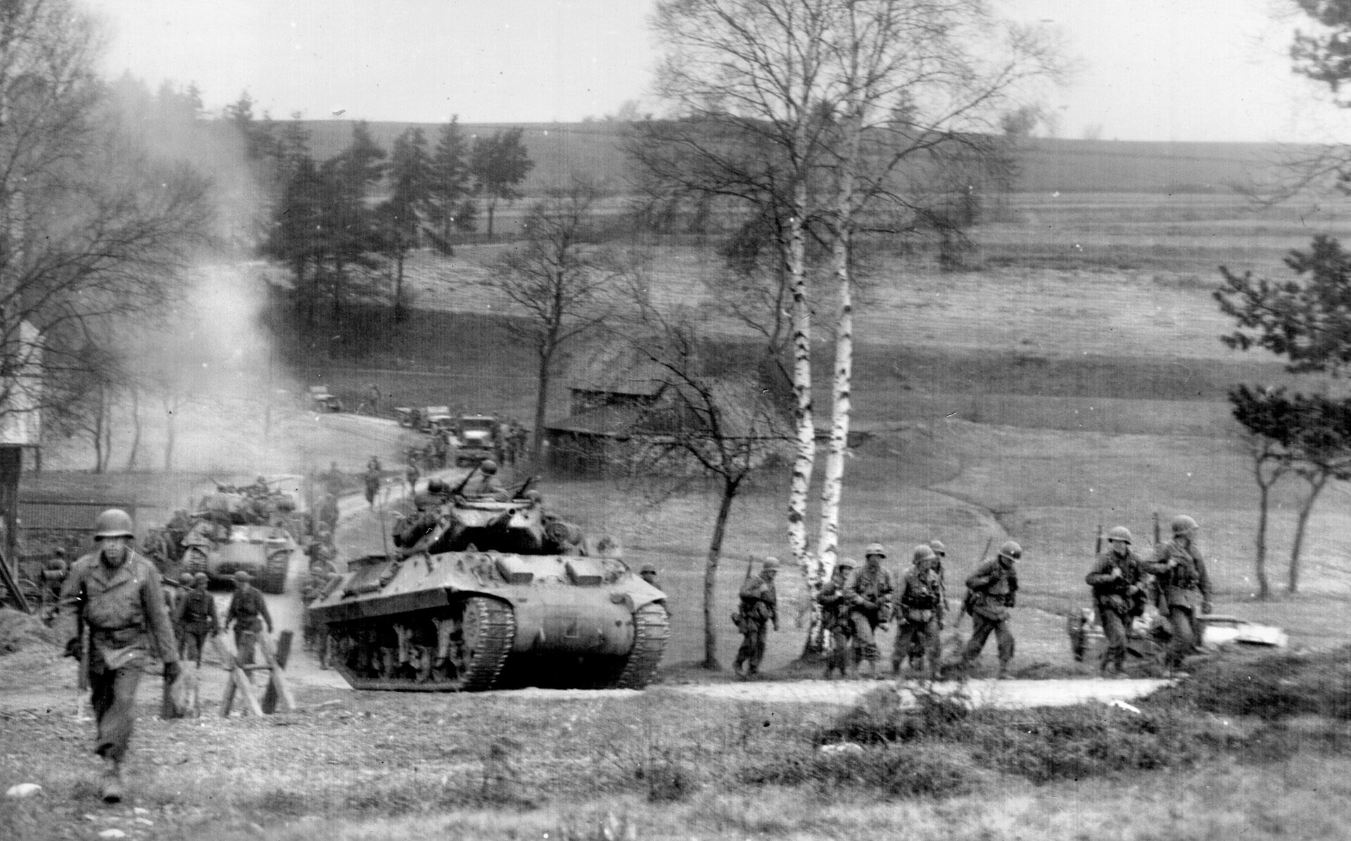 Sherman tanks and Patton’s Third Army infantrymen advance together across the German-Czech border, April 1945. The relationship between the two forces was beneficial for both. 
