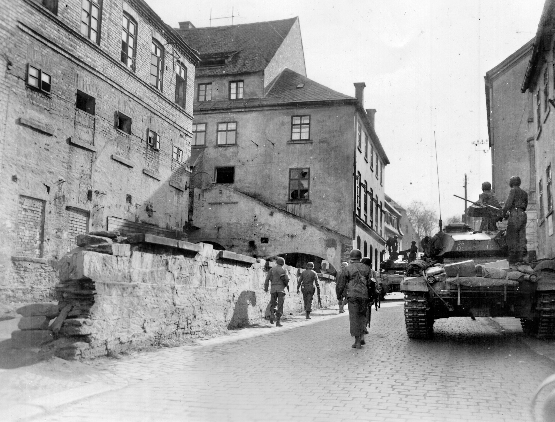A tankmen on an M24 Chaffee “light” tank points his .50-caliber machine gun at a building in Cheb as 97th Infantry Division troops move through the town. The Chaffee, with a 75mm main gun, began replacing the obsolete M5 Stuart tank in late 1944.