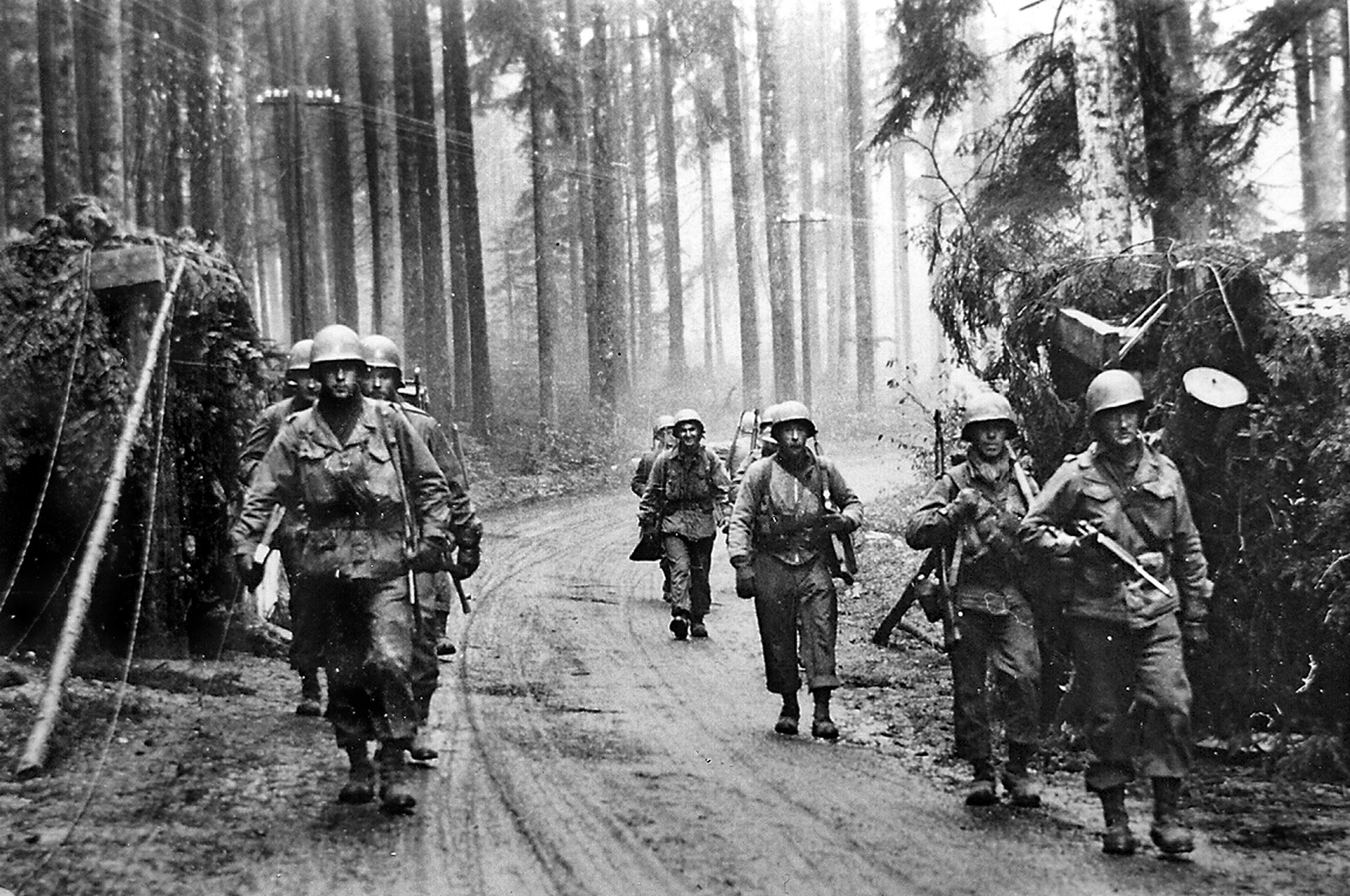 Soldiers of the U.S. Seventh Army move past a roadblock cleared by engineers in a forest in the Alsace region of France. The Seventh was stretched thin at the time of Nordwind because it had to extend its northern flank to cover ground previously held by the Third Army, which counterattacked German forces during the Battle of the Bulge. 