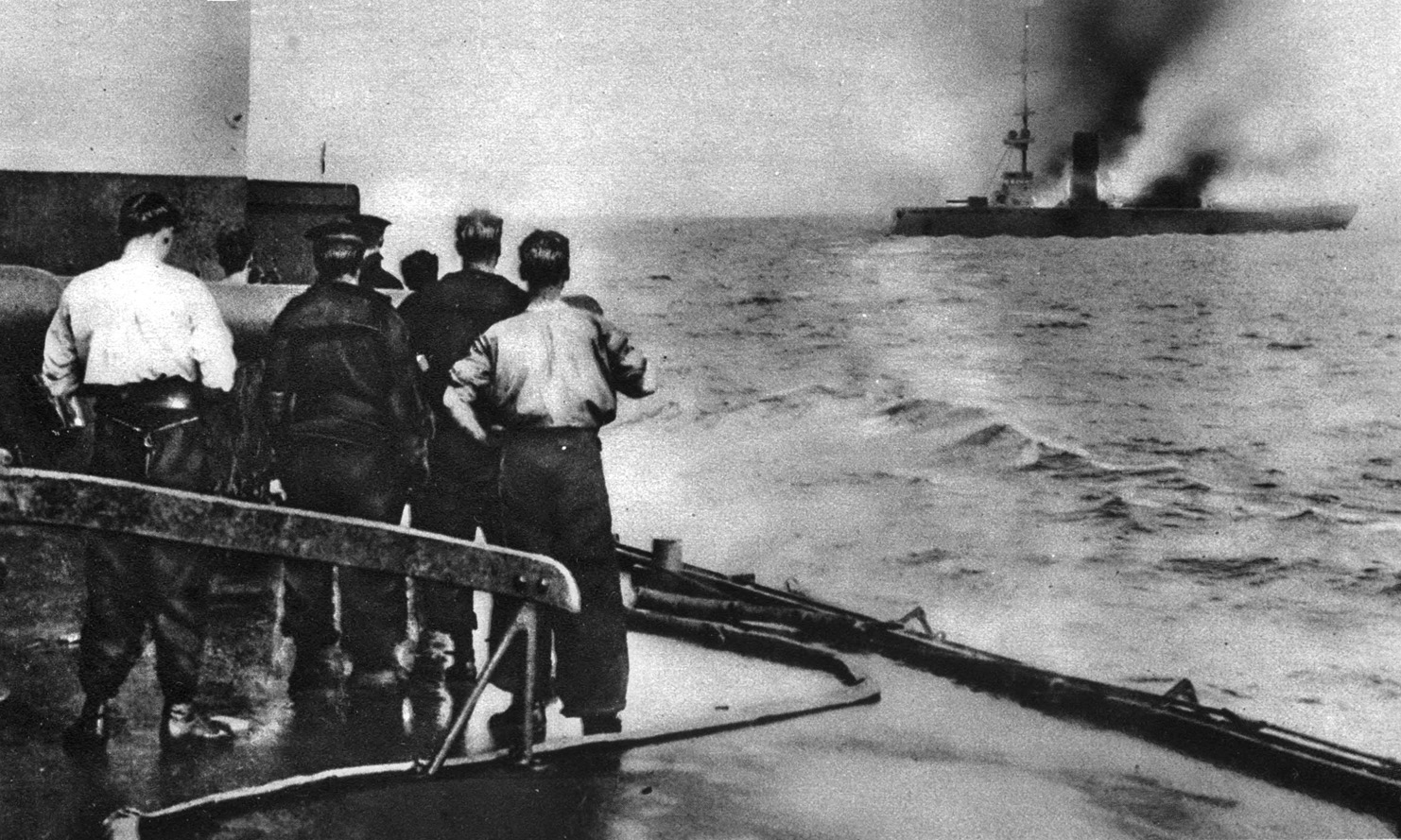 British sailors watch as the German cruiser Mainz suffers crippling fire. The German light cruisers were no match for superior British tactics and firepower at Heligoland Bight.