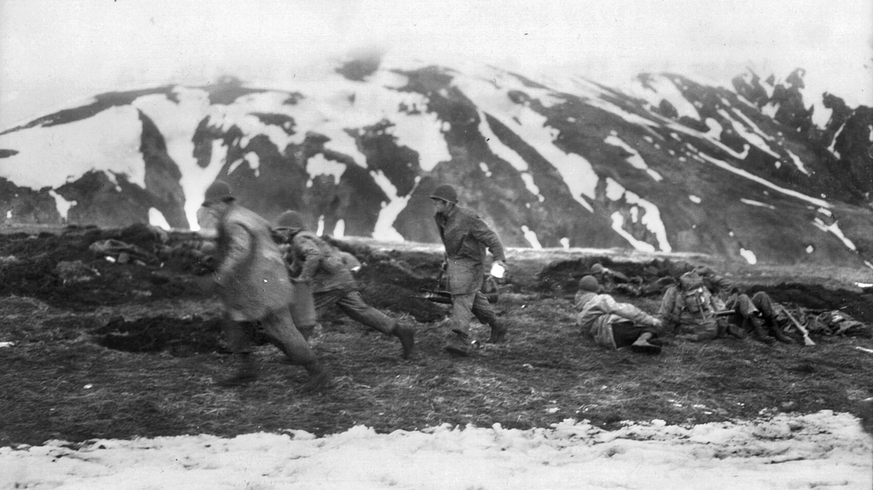 Americans run for cover as a Japanese sniper fires at them during the Battle of Attu.