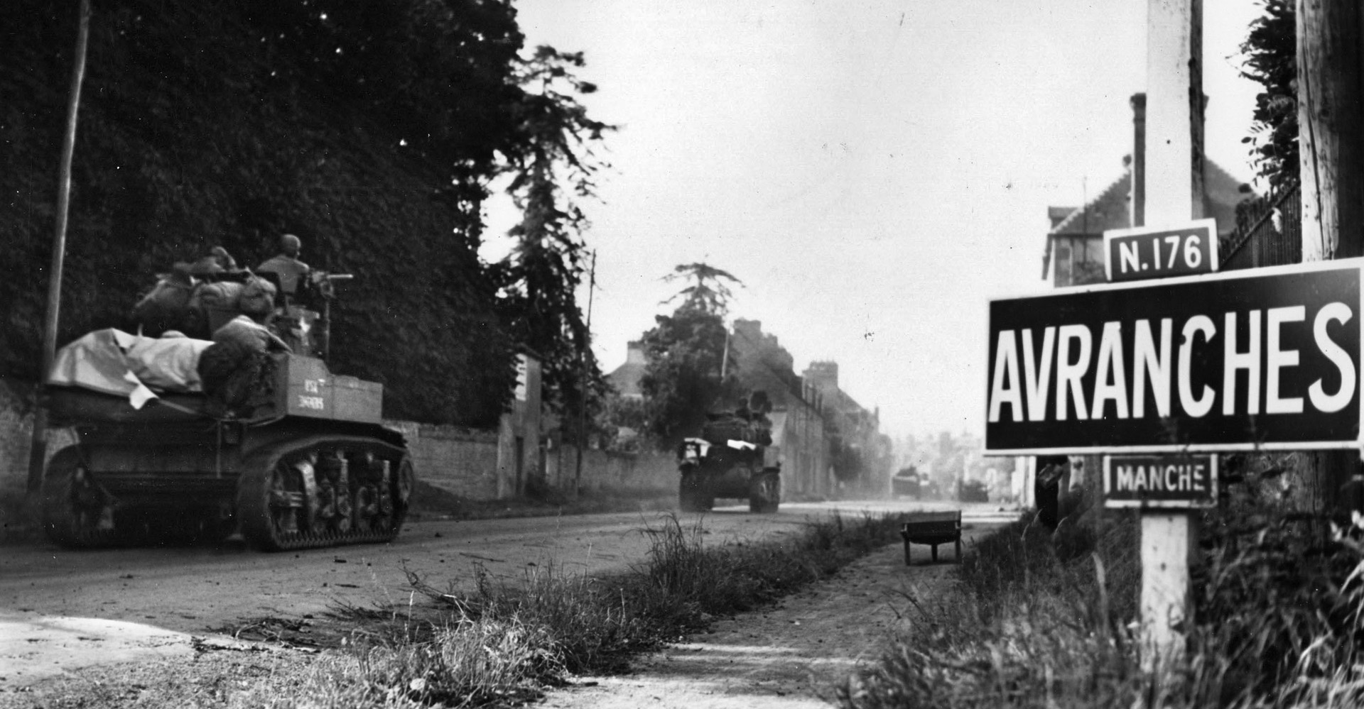 A column of American tanks rushes into the city of Avranches to knock out pockets of resistance, August 1, 1944.