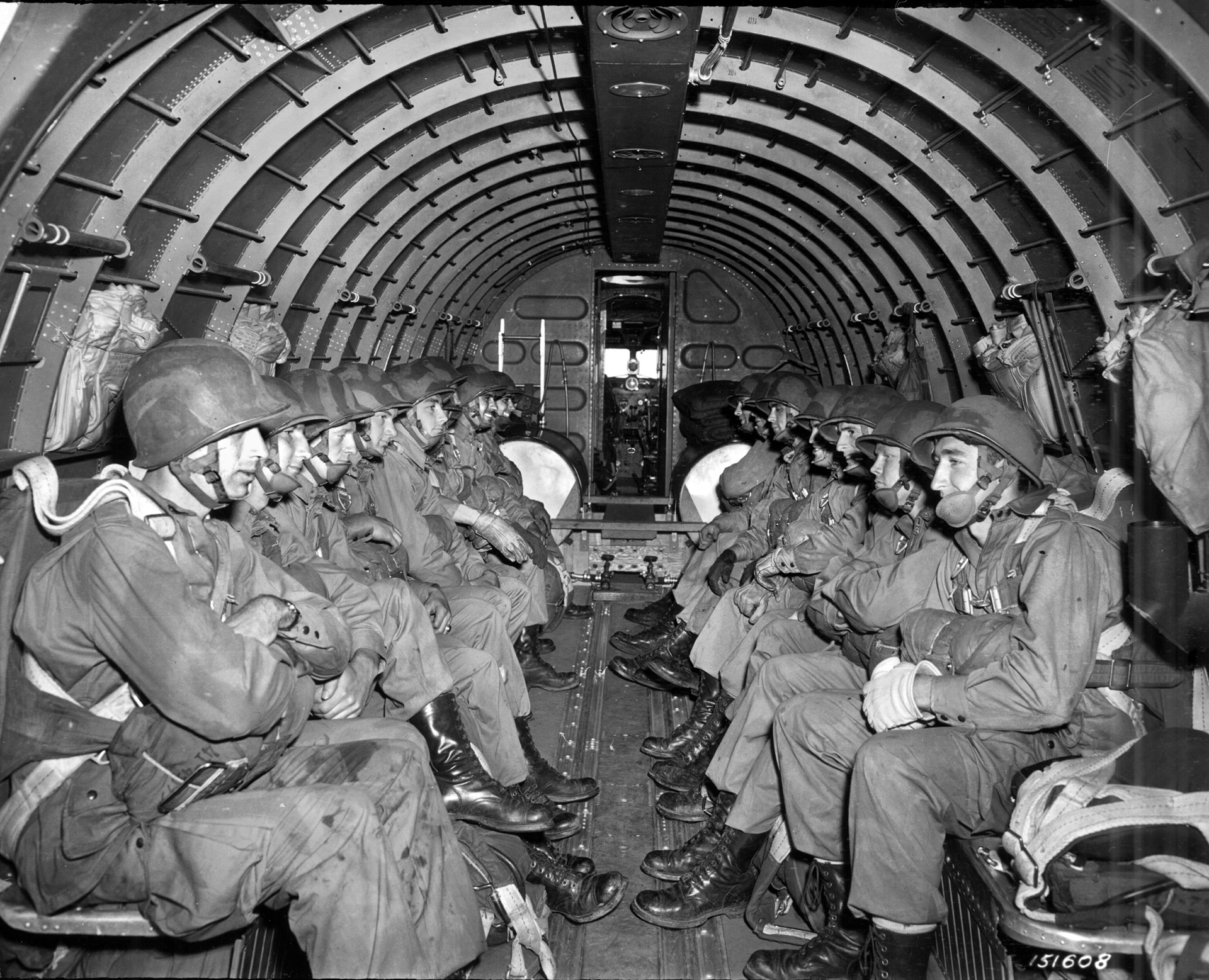 During the same training exercise from October 1942, these 509th PIR troopers sit aboard a Douglas C-47 transport aircraft and await orders to stand up, hook up, and jump. The aircraft is from the 60th Troop Carrier Group, the same unit that would carry the 509th into action in North Africa.