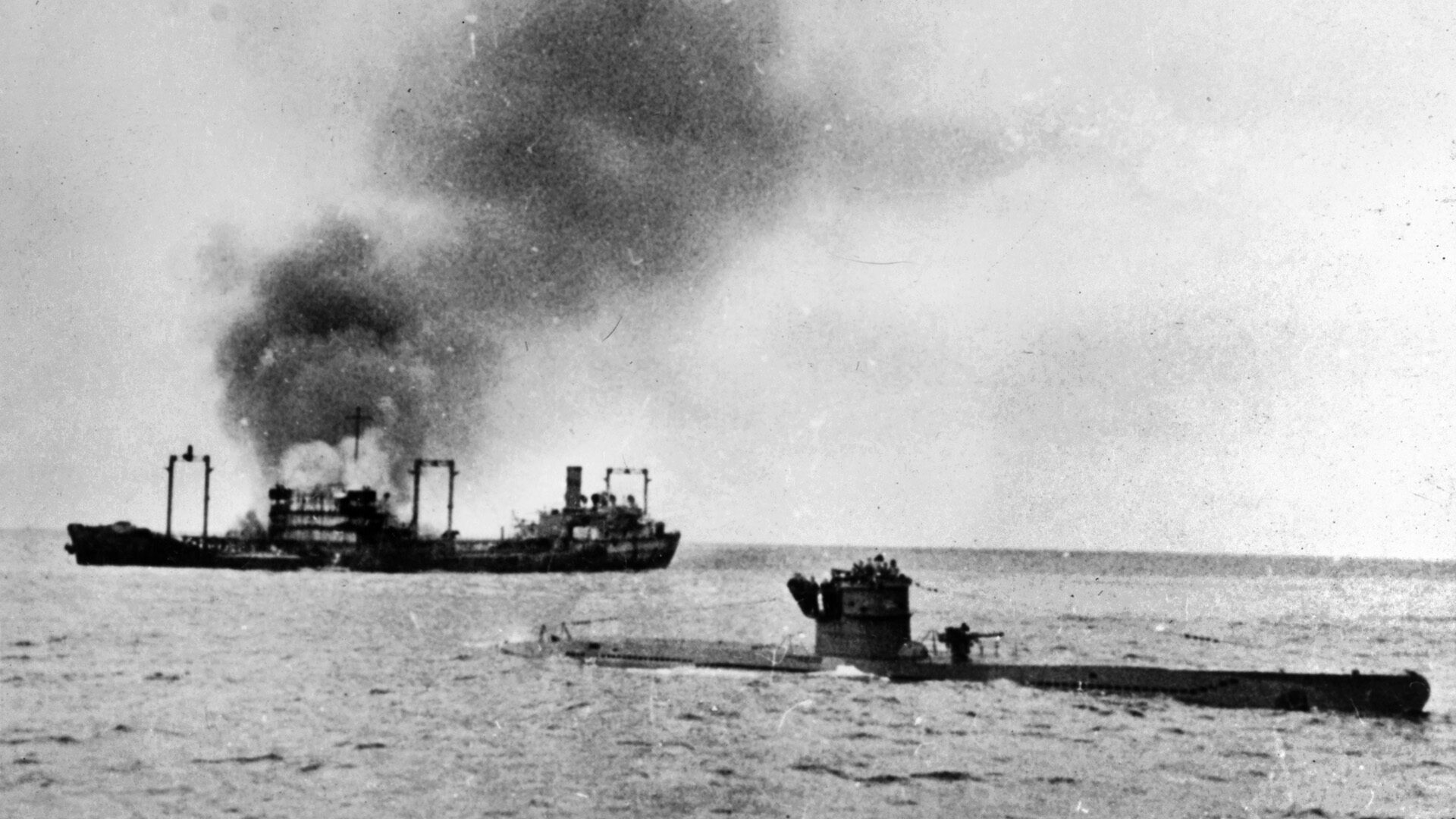 Riding on the surface off the coast of North Africa, the Nazi submarine U-442 and her crew remain near a burning tanker, torpedoed in January 1943, its cargo of precious fuel going to the bottom.