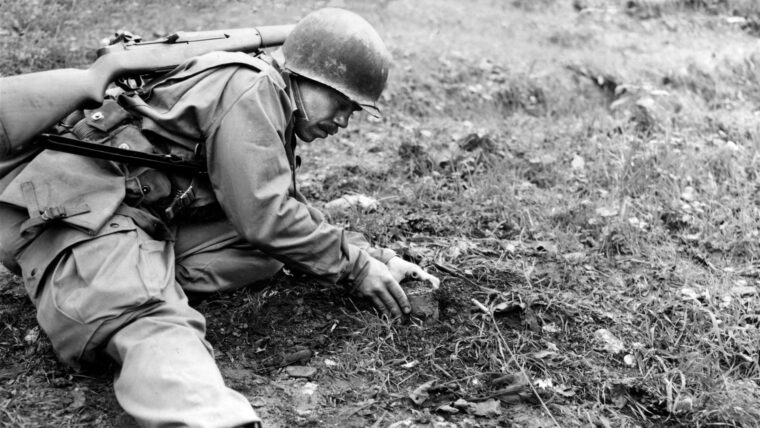 An American soldier gently removes the detonator from an S-mine, which was capable of severely injuring any man unfortunate enough to step on it. The Germans defending Mount Porchia planted thousands of land mines to impede Allied progress.