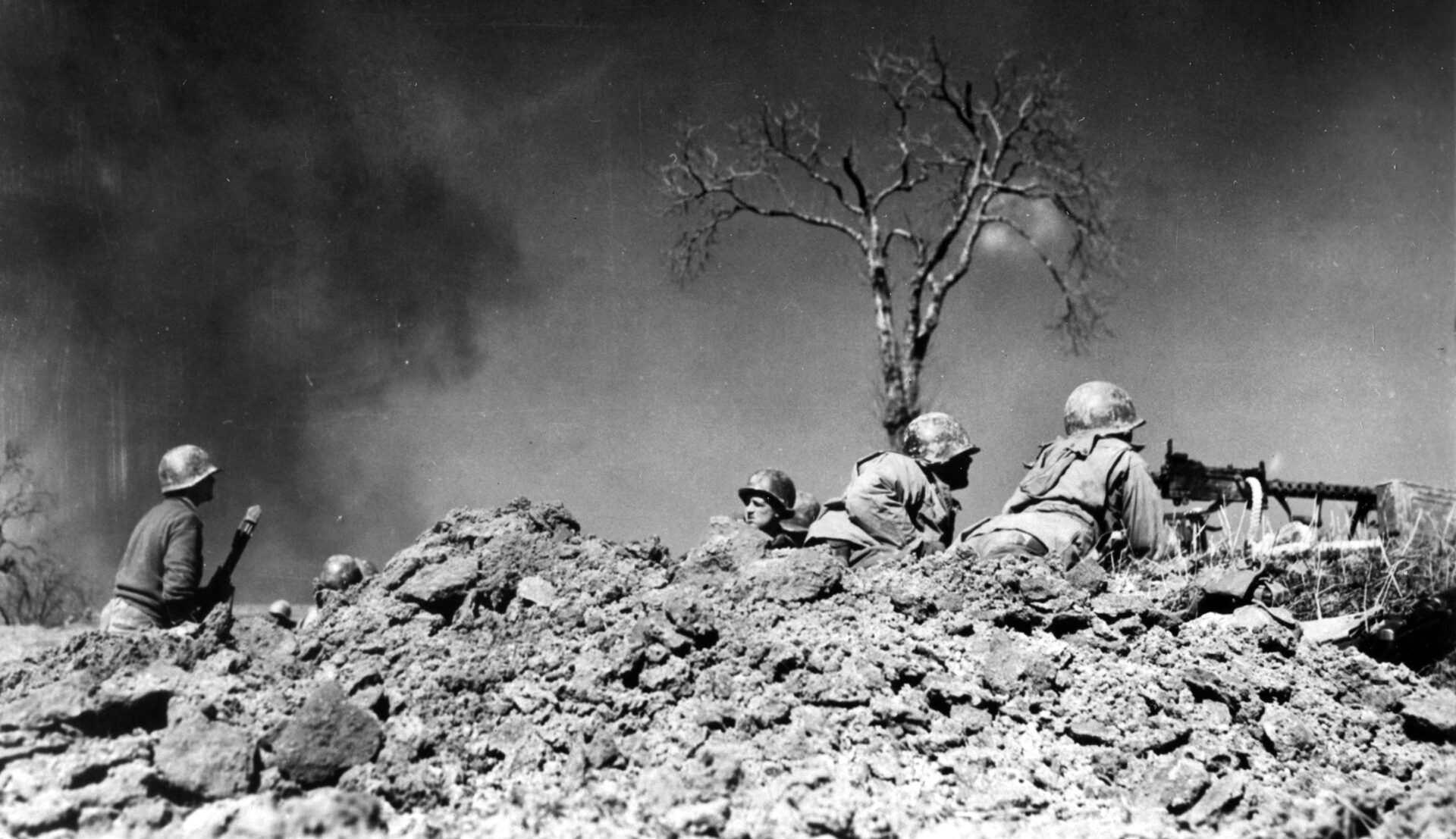 GIs on a hilltop in Italy train their machine gun on Germans some 200 yards away. On January 6th troops from the 6th Armored Infantry fought their way to the top of Mount Porchia but later that evening an attack from the Hermann Goering Division forced them back down the mountain. 