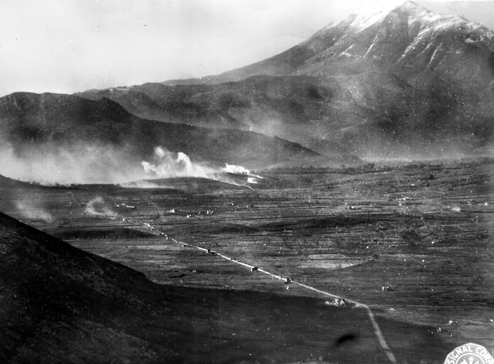 On January 6, 1944, the third day of the assault on Mount Porchia, American artillery pounds German positions in preparation for another attempt to take the promontory. 