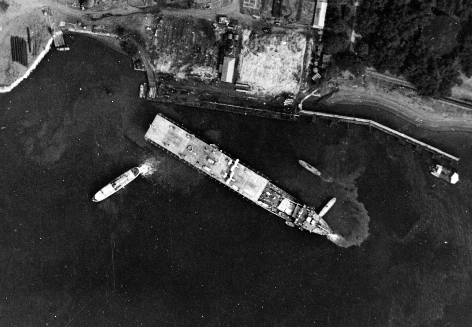 Converted to her seaplane tender configuration and designated AV-3, USS Langley is shown off Sangley Point, Philippine Islands, in October 1941, just weeks before the Japanese attack on Pearl Harbor and U.S. entry into World War II. Note that the forward section of the flight deck has been removed.