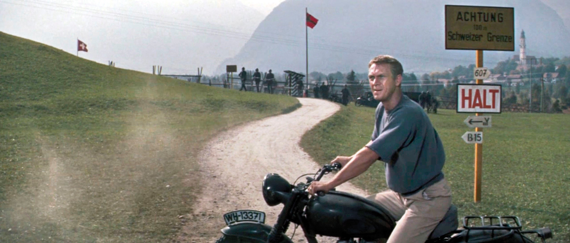 Actor Steve McQueen portrays the “Cooler King” in the film The Great Escape, a character inspired by Bill Ash.