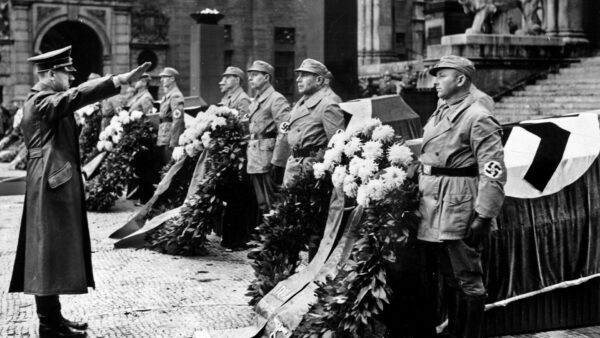 Adolf Hitler gives a stiff Nazi salute to seven men killed in an assassination attempt in Munich during the 1939 anniversary observances of the failed Munich Beer Hall Putsch of 1923.