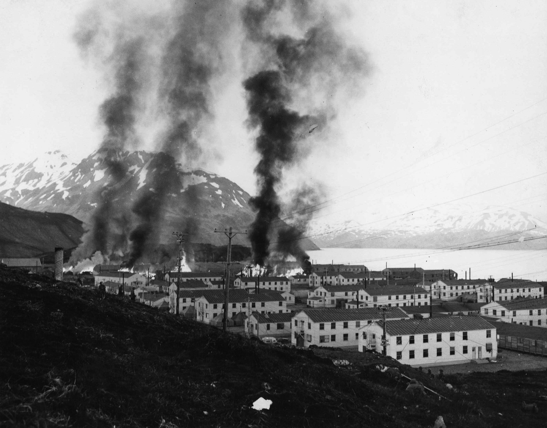 Smoke rises from the U.S. naval facility at Dutch Harbor in Alaska’s Aleutian Islands following an attack by Japanese carrier-launched torpedo aircraft on June 3, 1942. When Japanese forces occupied Attu and Kiska, it fell to the thin forces of the U.S. Alaska Defense Command to begin the initial counterattack.