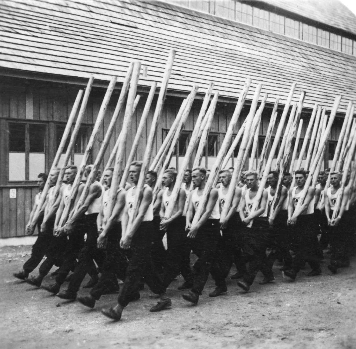 Karl’s RAD unit marching with heavy poles as part of its physical training.