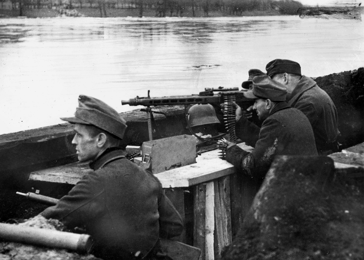 German troops man an MG 42 along the western bank of the Oder River on the Eastern Front in the final months of World War II. The versatile MG 42 could be used with a tripod as a heavy machine gun remaining in a fixed position or with a bipod as a light machine gun when needed to counterattack an enemy assault.