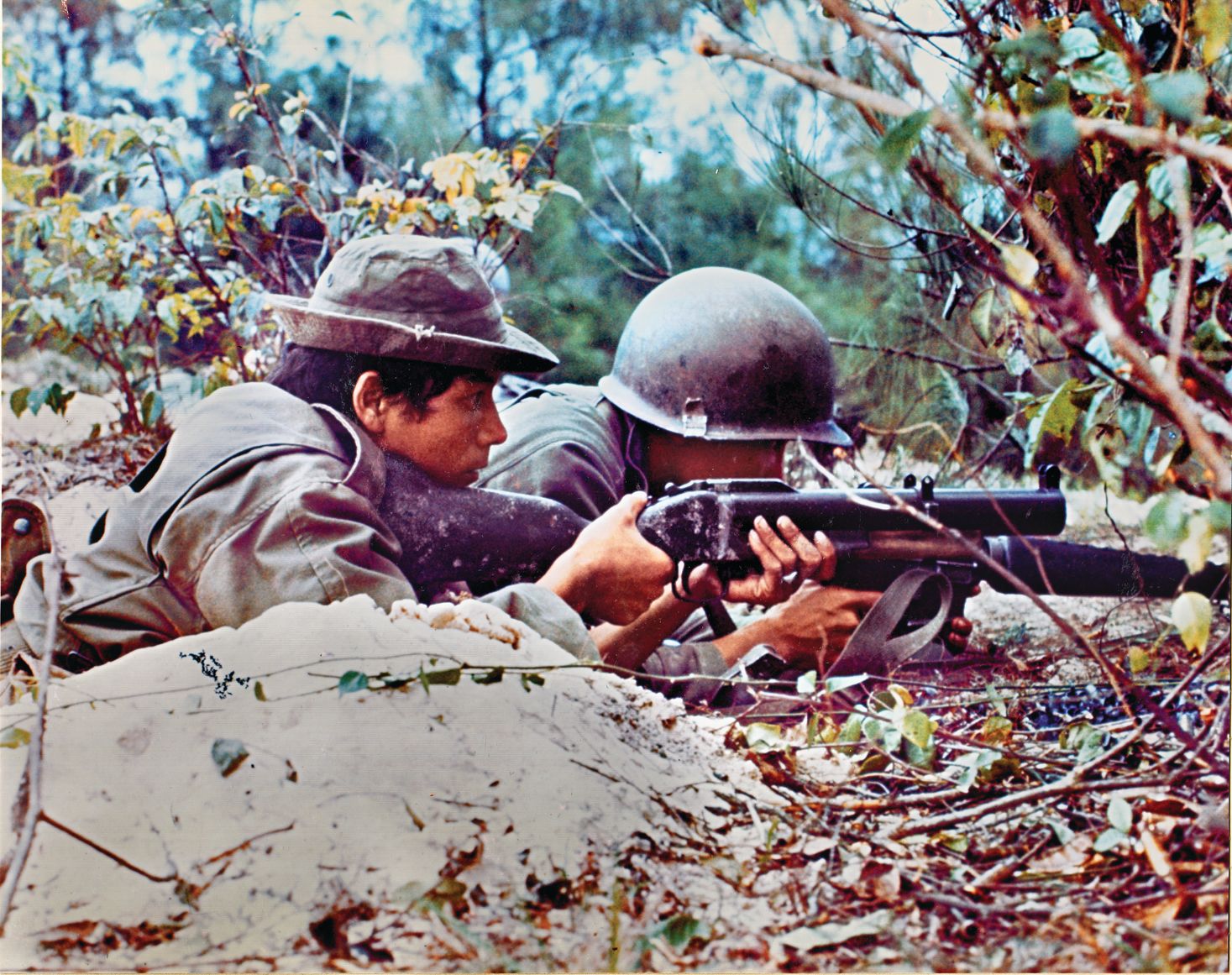 Sharpshooting South Vietnamese riflemen exchange fire with enemy fighters near Quang Tri, below the DMZ.