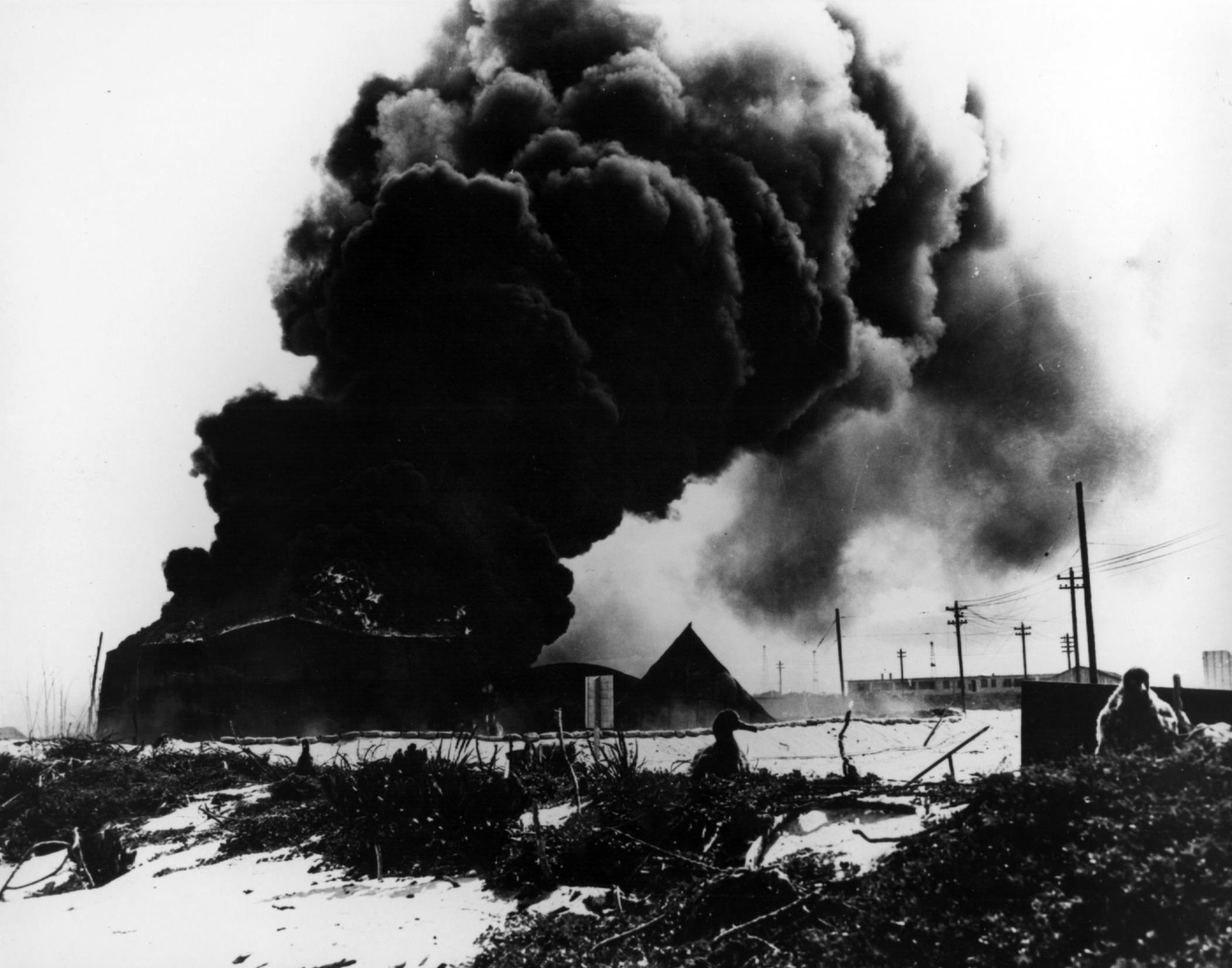 Burning oil tanks on Sand Island, Midway, after a Japanese air attack on June 4, 1942.