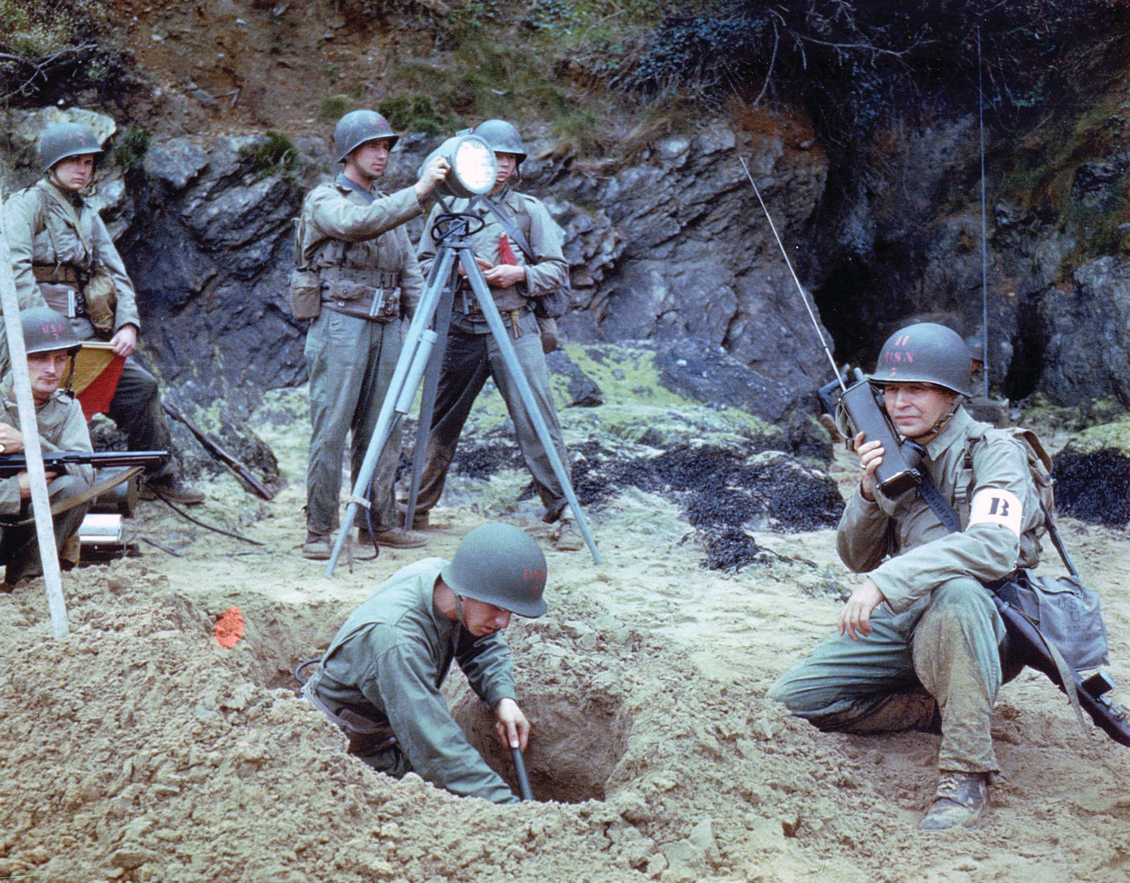 U.S. Navy Beach Masters communicate with ships offshore with walkie-talkies and signal lamps. 