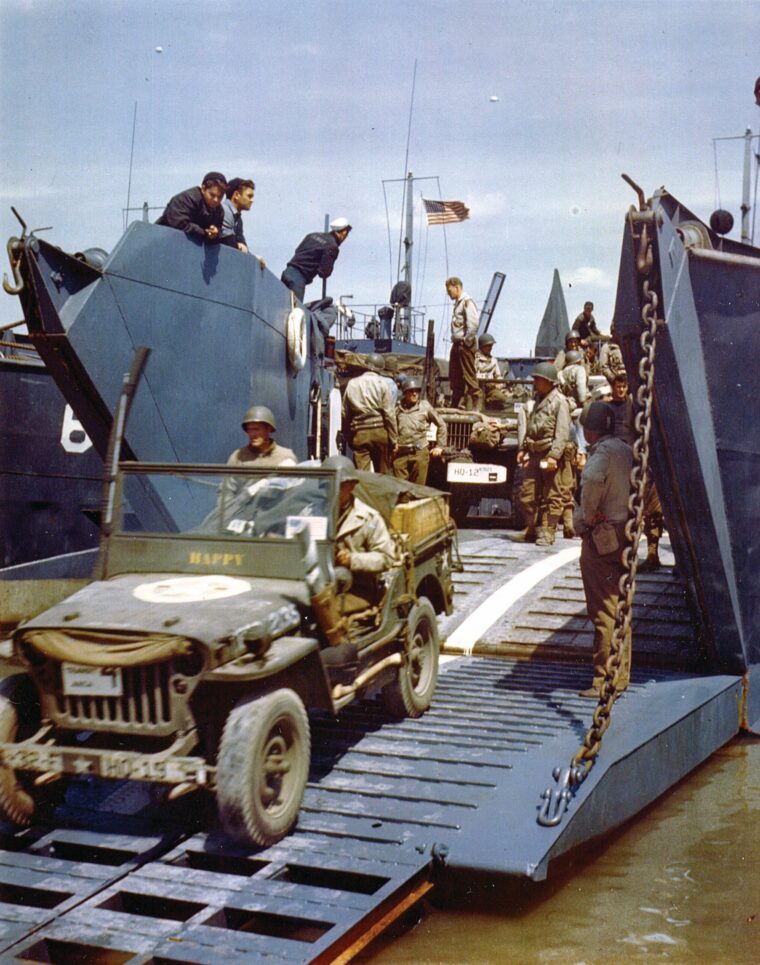 Soldiers drive a jeep off an LST. Notice the snorkel attached to the right side of the windshield to prevent saltwater from pouring into the exhaust.