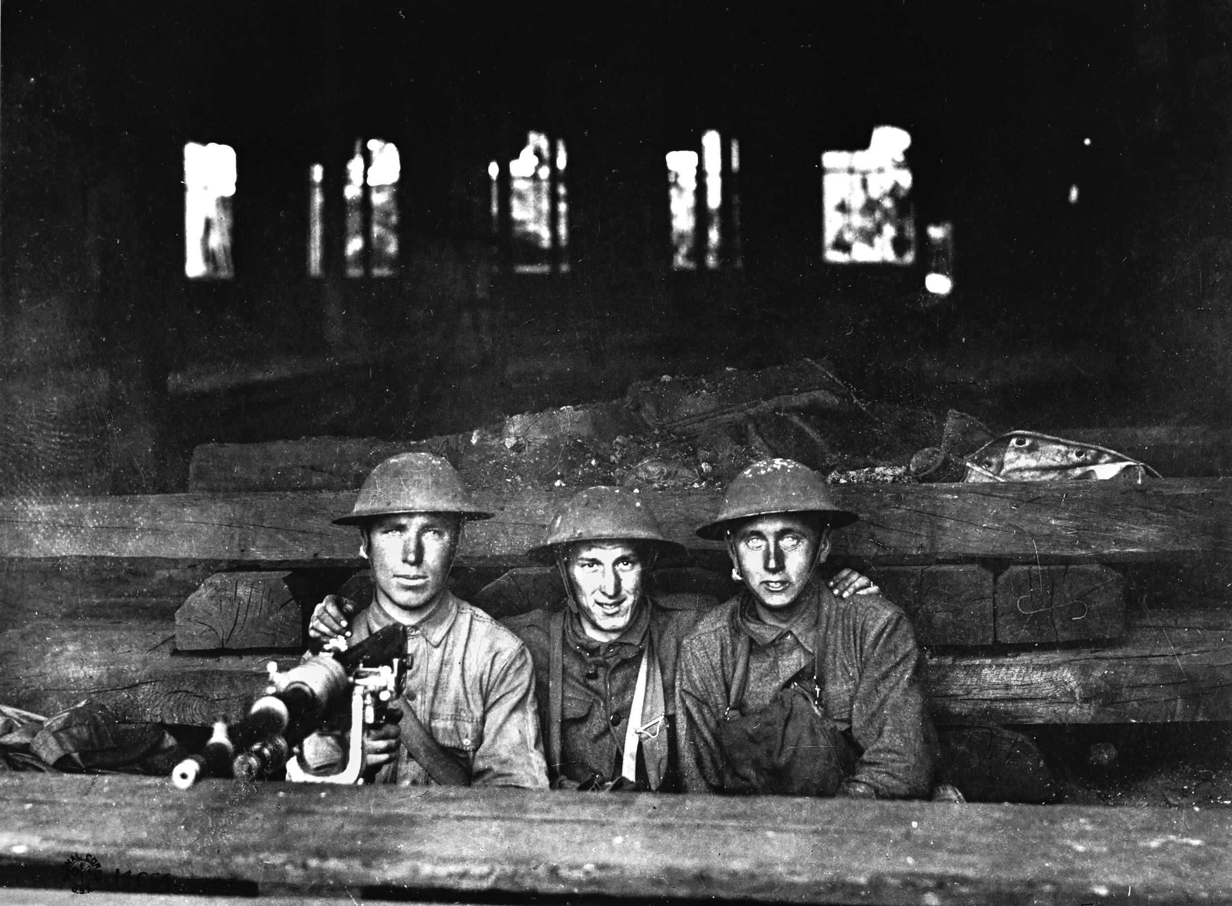 Confident doughboys man a machine-gun emplacement in a railroad building at Chateau-Thierry in a photo taken on June 7, 1918.