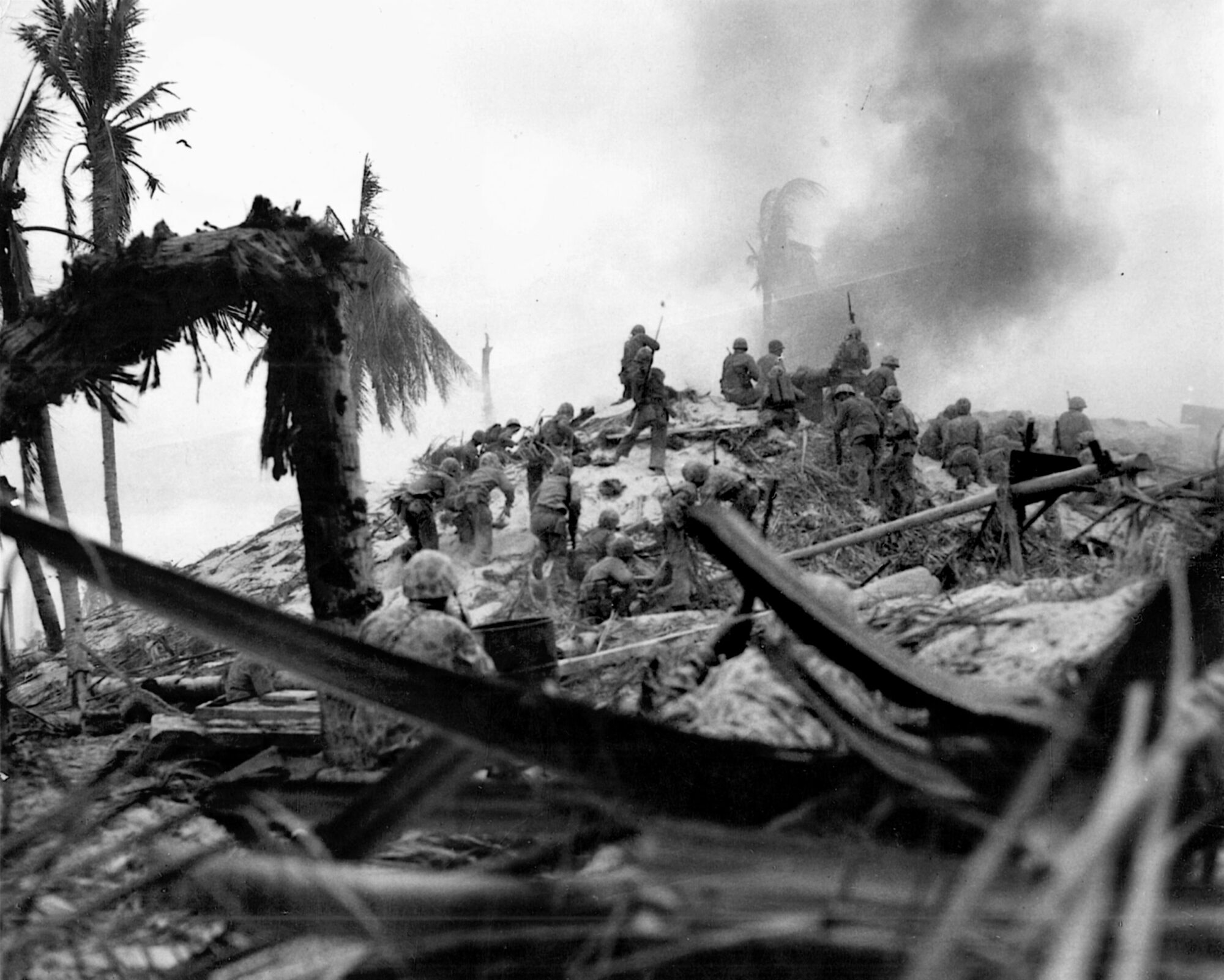 1st Lt. Alexander Bonnyman, Jr., identified by a faint arrow drawn on this image by combat photographer Obie Newcomb, leads a contingent of Marines in an attack on the two-story blockhouse believed to be the headquarters of the Japanese commander at Tarawa, Rear Admiral Keiji Shibasaki. The assault succeeded, but Bonnyman was killed in the action and received a posthumous Medal of Honor.