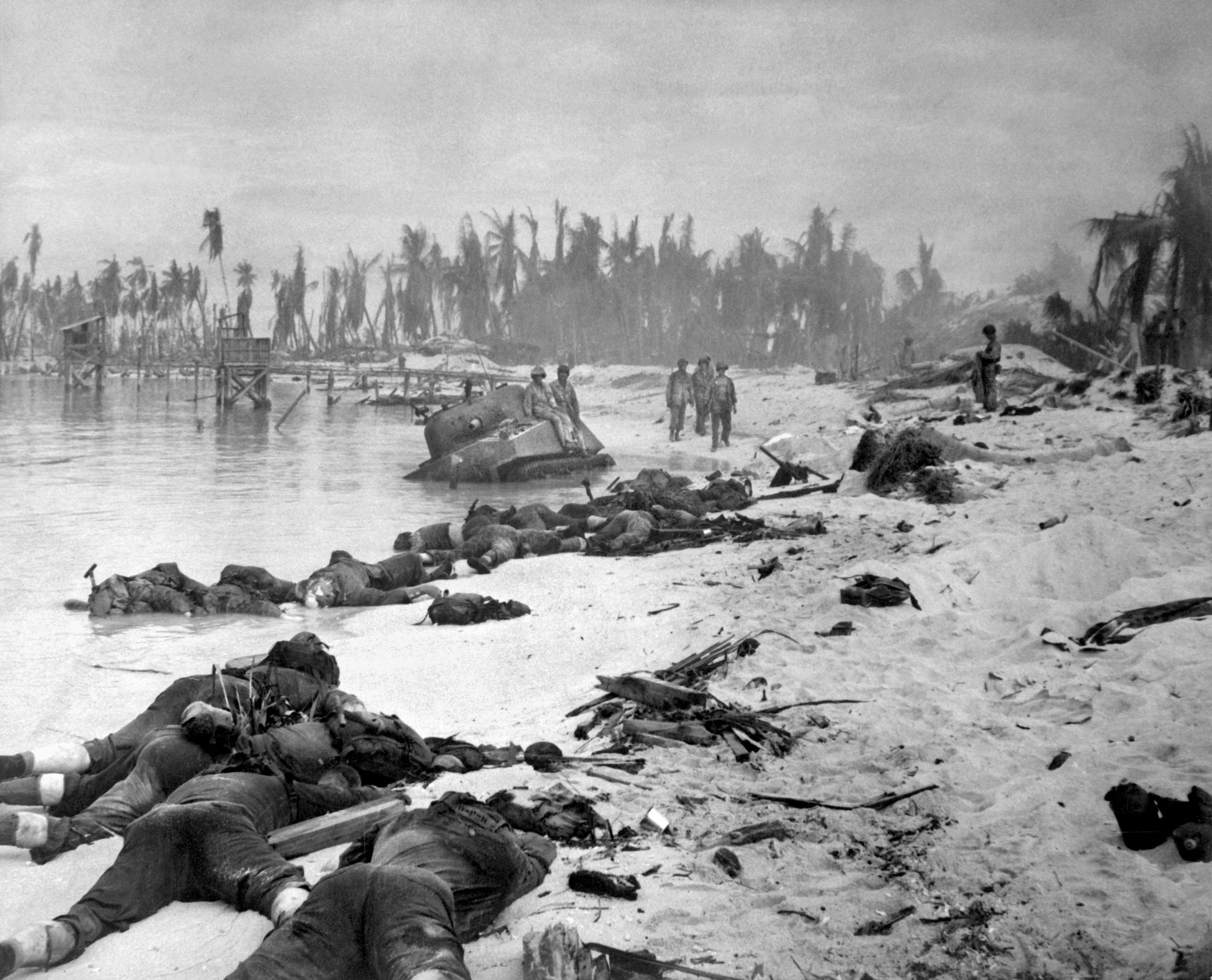 The Japanese defenders of Betio had presighted their weapons, subjecting the Marines to interlocking fields of fire that took a heavy toll. A Sherman tank lies disabled in the shallow water; few of the American tanks committed to the landing actually made it ashore, but those that did helped tip the balance in the Marines’ favor. The American public, shocked by images such as these, demanded censure of the American commanders who had ordered the assault.