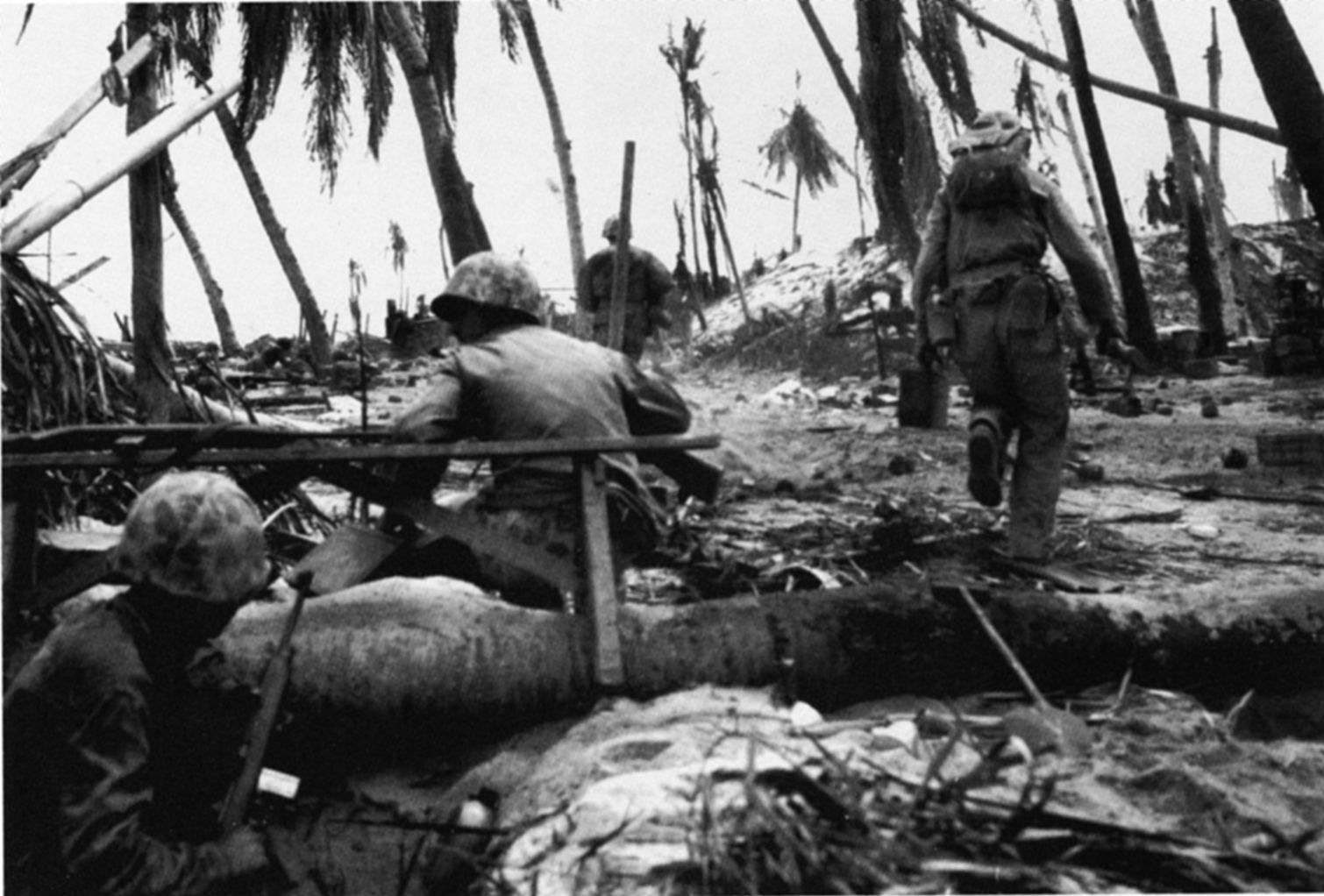 The fighting on Betio was ferocious, and Marines often measured their gains in yards. Small teams of Marines methodically assaulted Japanese strongpoints on the islet and opened the way for offensive operations Here, a group of Marines braves intense fire to attack a Japanese bunker (background). 